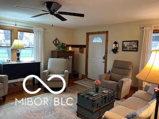 living area featuring a ceiling fan