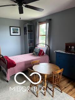bedroom featuring wood finished floors and a ceiling fan