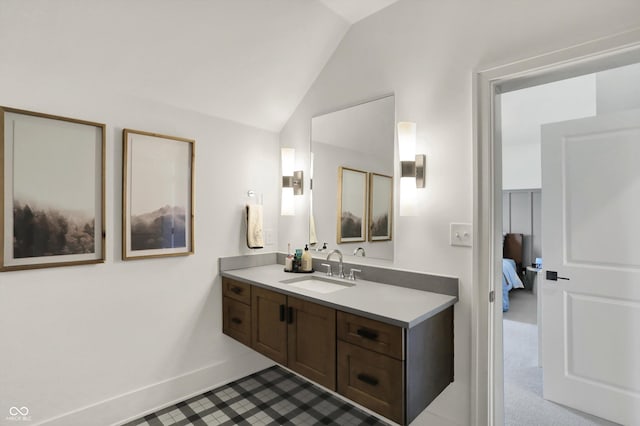 5130 Melbourne Pl, Zionsville, IN 46077 - ensuite bathroom featuring vanity, lofted ceiling, and baseboards