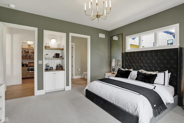 5130 Melbourne Pl, Zionsville, IN 46077 - bedroom featuring a chandelier, light carpet, ensuite bath, and baseboards