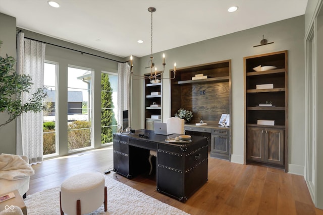 5130 Melbourne Pl, Zionsville, IN 46077 - office space featuring a chandelier, wood finished floors, recessed lighting, and built in features