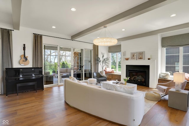 5130 Melbourne Pl, Zionsville, IN 46077 - living area with beamed ceiling, light wood finished floors, a glass covered fireplace, and recessed lighting