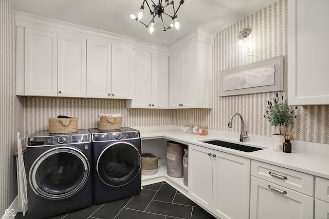 5130 Melbourne Pl, Zionsville, IN 46077 - laundry area featuring wallpapered walls, washing machine and dryer, cabinet space, dark tile patterned flooring, and a chandelier