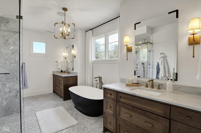 5130 Melbourne Pl, Zionsville, IN 46077 - full bathroom with a shower stall, a soaking tub, two vanities, a chandelier, and baseboards