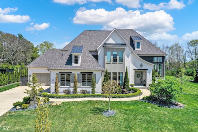 5130 Melbourne Pl, Zionsville, IN 46077 - view of front of home with a standing seam roof, a front yard, concrete driveway, stucco siding, and a garage