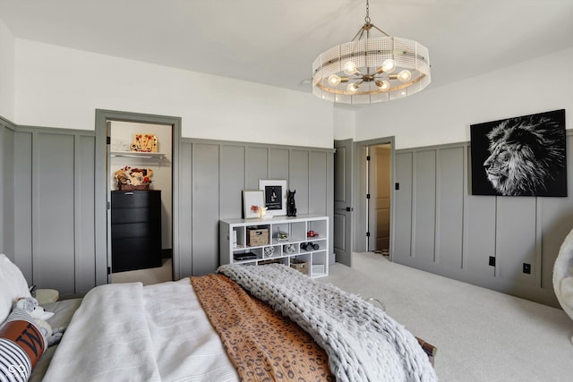 5130 Melbourne Pl, Zionsville, IN 46077 - carpeted bedroom featuring a decorative wall, a chandelier, and wainscoting