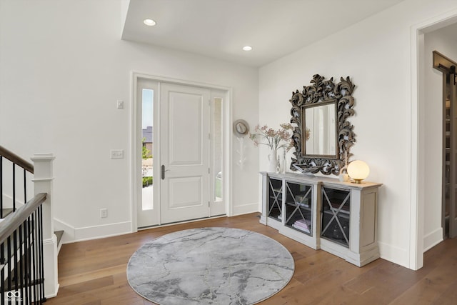 5130 Melbourne Pl, Zionsville, IN 46077 - foyer entrance with wood finished floors, baseboards, recessed lighting, and a barn door