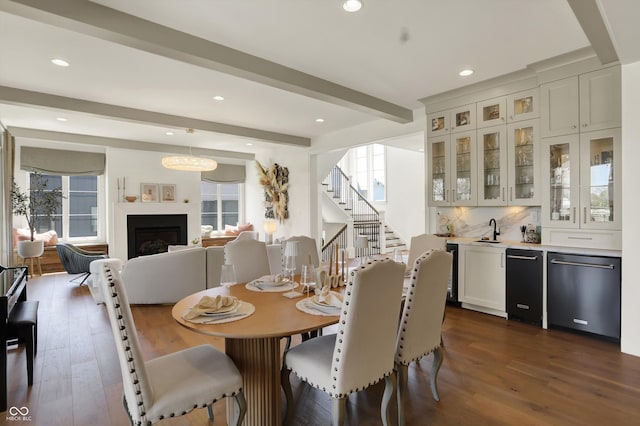 5130 Melbourne Pl, Zionsville, IN 46077 - dining area featuring dark wood finished floors, beamed ceiling, recessed lighting, stairway, and a fireplace