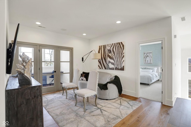 5130 Melbourne Pl, Zionsville, IN 46077 - living area with french doors, wood finished floors, recessed lighting, and baseboards