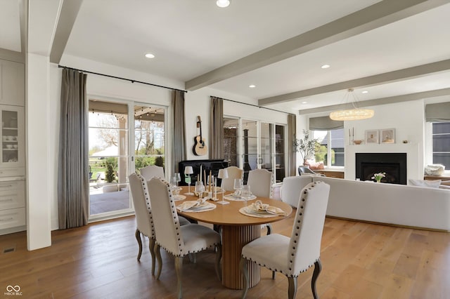 5130 Melbourne Pl, Zionsville, IN 46077 - dining area with plenty of natural light, beamed ceiling, light wood-type flooring, recessed lighting, and a fireplace