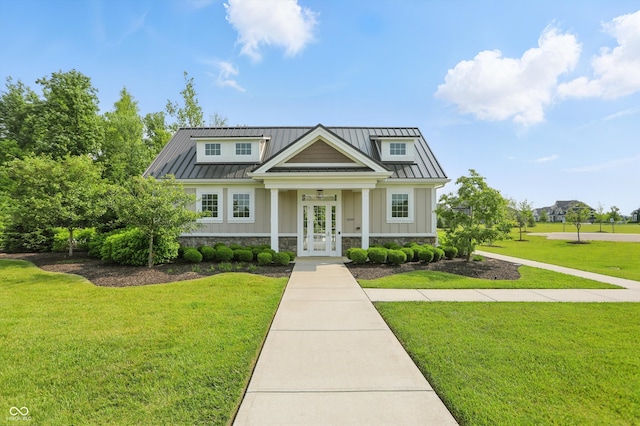 5130 Melbourne Pl, Zionsville, IN 46077 - view of front facade with a standing seam roof, french doors, and a front lawn