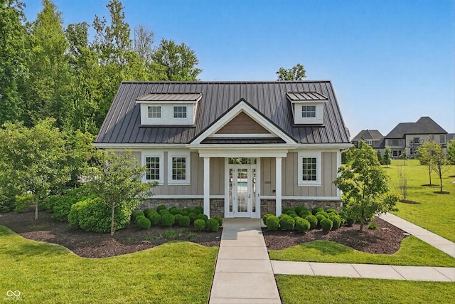 5130 Melbourne Pl, Zionsville, IN 46077 - view of front of home with french doors, a front yard, metal roof, and a standing seam roof