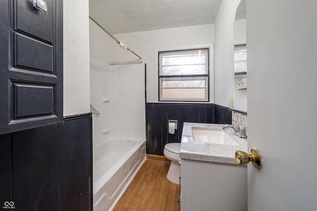 3510 Chamberlin Dr, Indianapolis, IN 46237 - full bathroom with wainscoting, wood finished floors, toilet, shower / bath combination, and a sink