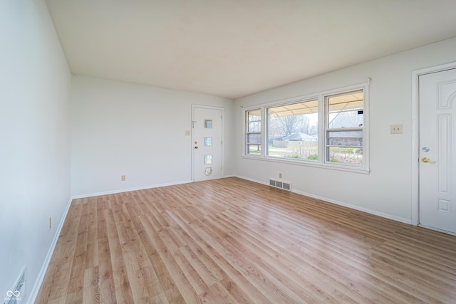 3510 Chamberlin Dr, Indianapolis, IN 46237 - unfurnished living room featuring light wood-style floors, baseboards, and visible vents