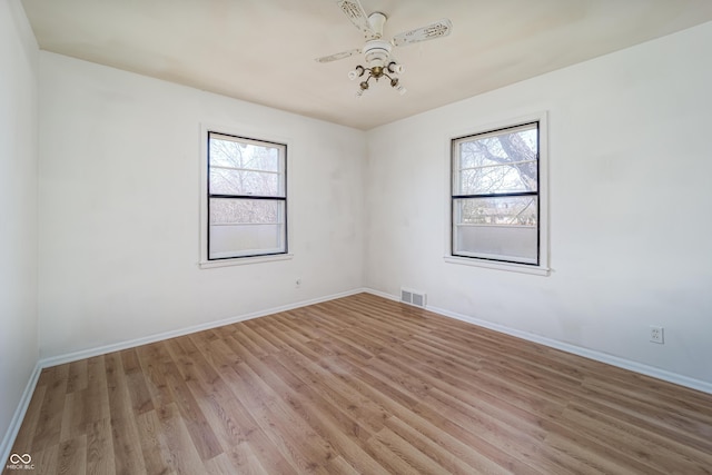 3510 Chamberlin Dr, Indianapolis, IN 46237 - empty room with a healthy amount of sunlight, baseboards, light wood-style floors, and visible vents