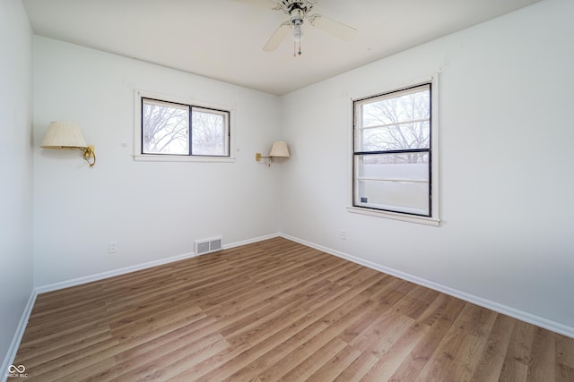 3510 Chamberlin Dr, Indianapolis, IN 46237 - spare room with visible vents, light wood finished floors, ceiling fan, and baseboards