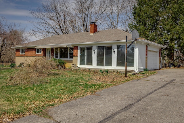 3510 Chamberlin Dr, Indianapolis, IN 46237 - single story home featuring a garage, aphalt driveway, roof with shingles, a chimney, and brick siding