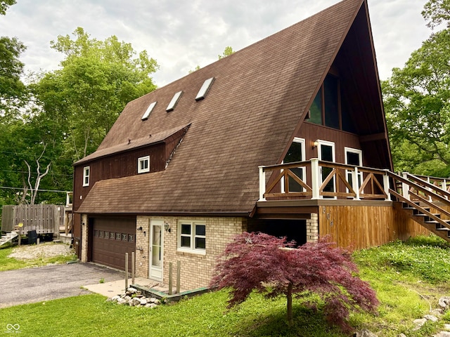 304 Oakridge Dr, North Vernon, IN 47265 - view of side of property featuring a garage, brick siding, asphalt driveway, stairway, and a shingled roof