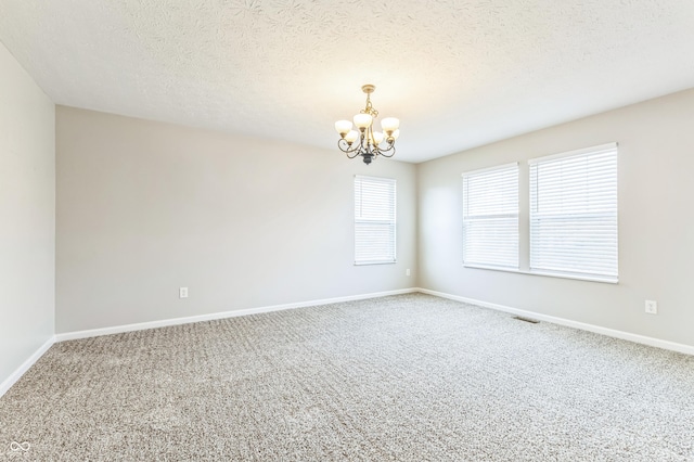 4747 Summit Lake Pl, Indianapolis, IN 46239 - empty room featuring a textured ceiling, visible vents, a chandelier, carpet, and baseboards