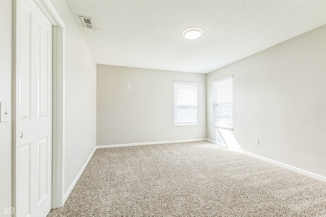 4747 Summit Lake Pl, Indianapolis, IN 46239 - unfurnished room with baseboards, carpet floors, a textured ceiling, and visible vents