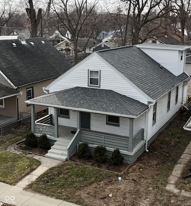 view of front of property featuring a shingled roof and covered porch