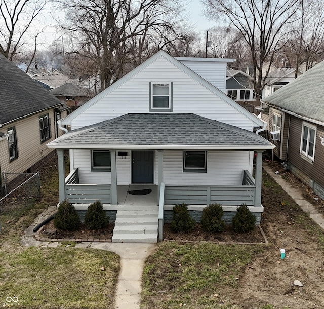 bungalow-style house with cooling unit, a porch, and roof with shingles