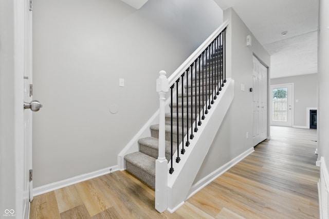 6059 S Bay Dr, Indianapolis, IN 46250 - staircase featuring baseboards and wood finished floors