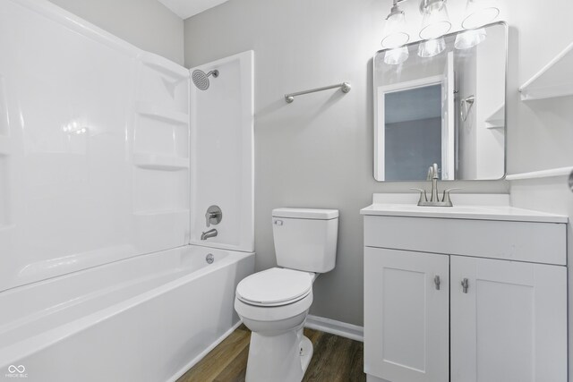 6059 S Bay Dr, Indianapolis, IN 46250 - full bath with toilet, vanity, bathing tub / shower combination, wood finished floors, and baseboards