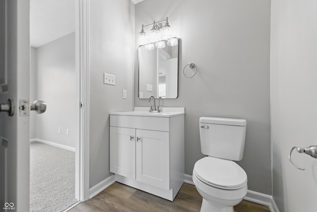 6059 S Bay Dr, Indianapolis, IN 46250 - bathroom featuring baseboards, toilet, and wood finished floors