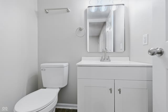 6059 S Bay Dr, Indianapolis, IN 46250 - half bathroom with toilet, vanity, and baseboards
