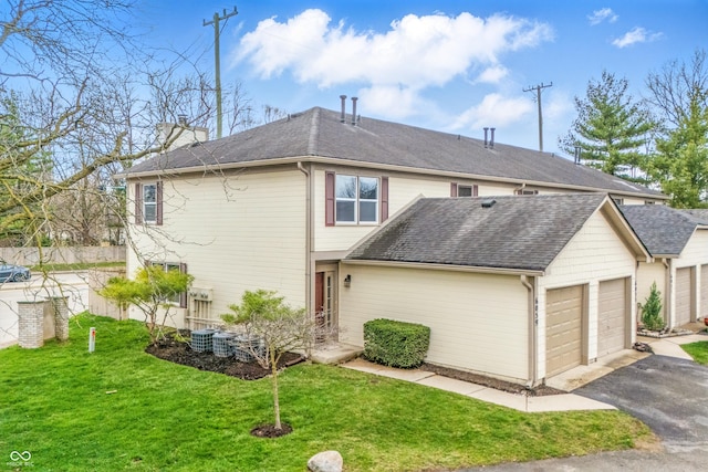 6059 S Bay Dr, Indianapolis, IN 46250 - exterior space with a lawn, driveway, a shingled roof, and an attached garage