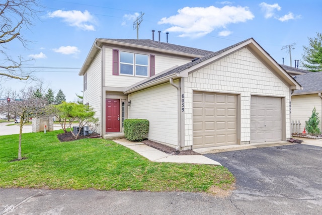 6059 S Bay Dr, Indianapolis, IN 46250 - traditional-style house with an attached garage, a shingled roof, and a front yard