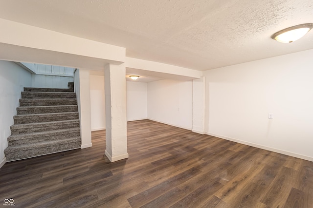 2134 Dawson St, Indianapolis, IN 46203 - finished basement featuring baseboards, a textured ceiling, dark wood finished floors, and stairway