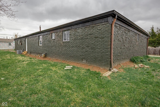 2134 Dawson St, Indianapolis, IN 46203 - view of home's exterior featuring a yard, cooling unit, and brick siding