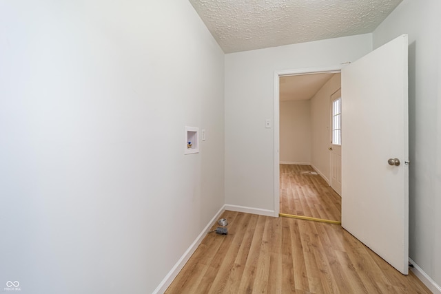 2134 Dawson St, Indianapolis, IN 46203 - laundry area with light wood-style floors, washer hookup, baseboards, and laundry area