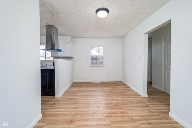 2134 Dawson St, Indianapolis, IN 46203 - unfurnished dining area featuring baseboards, light wood finished floors, and a textured ceiling