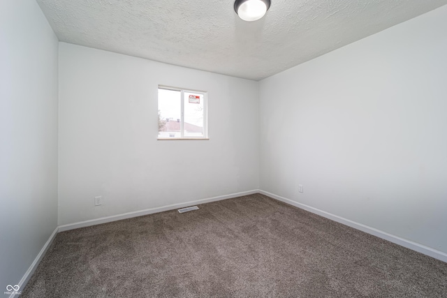 2134 Dawson St, Indianapolis, IN 46203 - carpeted empty room with a textured ceiling, visible vents, and baseboards