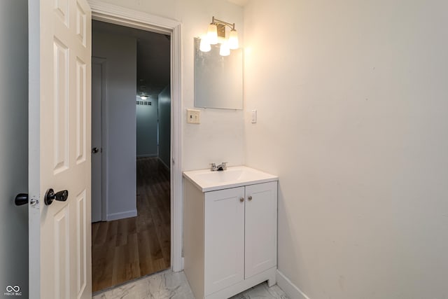 2134 Dawson St, Indianapolis, IN 46203 - bathroom featuring baseboards, vanity, and marble finish floor