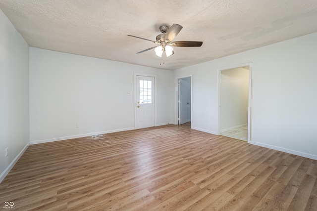 2134 Dawson St, Indianapolis, IN 46203 - empty room featuring a ceiling fan, baseboards, a textured ceiling, and light wood-style floors