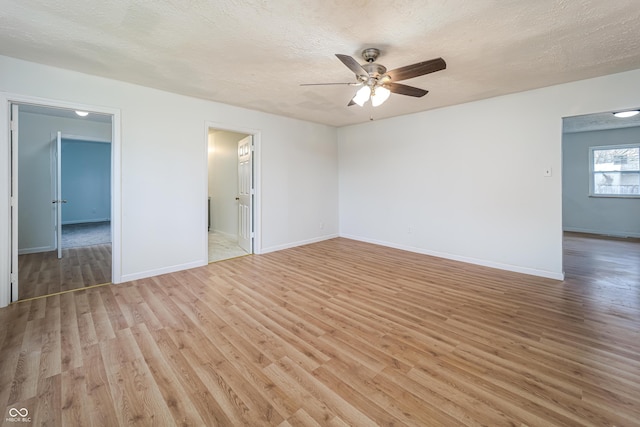 2134 Dawson St, Indianapolis, IN 46203 - interior space featuring baseboards, a ceiling fan, light wood finished floors, and a textured ceiling