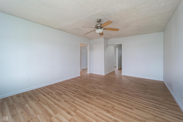 2134 Dawson St, Indianapolis, IN 46203 - spare room featuring baseboards, a ceiling fan, light wood finished floors, and a textured ceiling