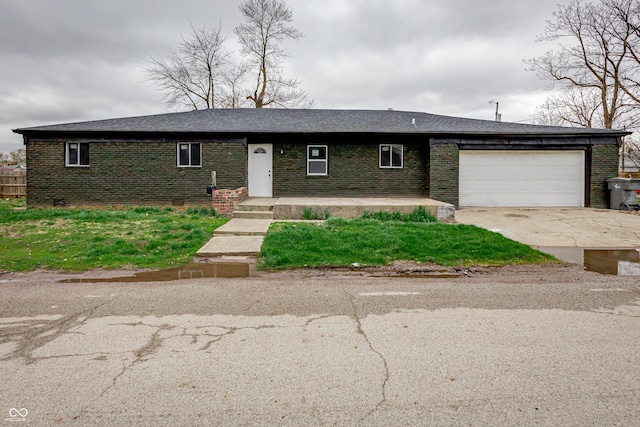 2134 Dawson St, Indianapolis, IN 46203 - ranch-style home featuring a shingled roof, an attached garage, driveway, and brick siding