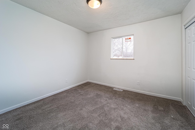 2134 Dawson St, Indianapolis, IN 46203 - carpeted spare room featuring a textured ceiling, baseboards, and visible vents