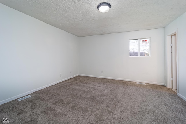 2134 Dawson St, Indianapolis, IN 46203 - empty room featuring baseboards, a textured ceiling, carpet, and visible vents