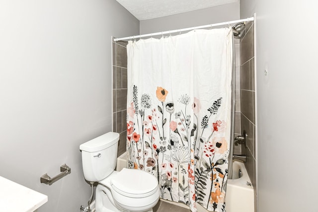 bathroom featuring shower / bath combination with curtain, a textured ceiling, and toilet
