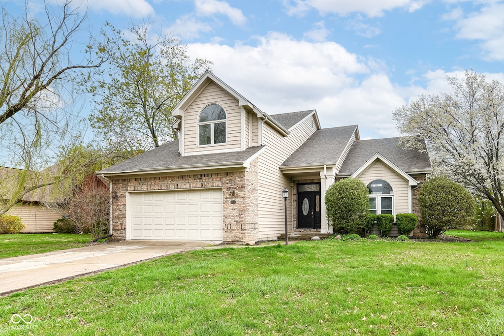 10516 Beacon Ln, Indianapolis, IN 46256 - traditional-style home with an attached garage, driveway, and a front lawn