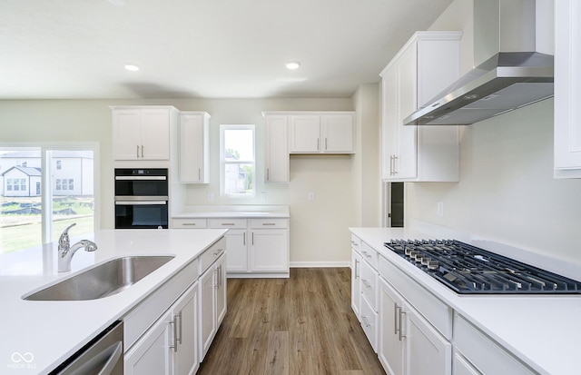 3241 Fawn Cir, Brownsburg, IN 46112 - kitchen featuring wall chimney exhaust hood, gas stovetop, a sink, dishwasher, and white cabinetry