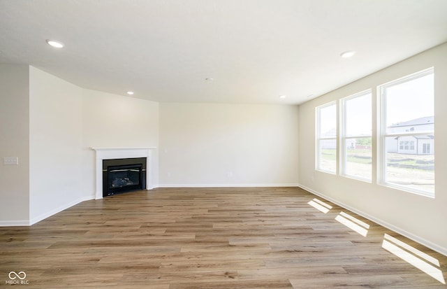 3241 Fawn Cir, Brownsburg, IN 46112 - unfurnished living room featuring light wood finished floors, recessed lighting, a fireplace, and baseboards