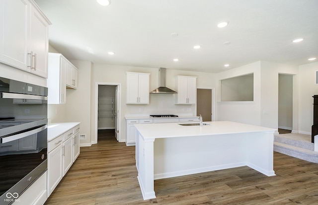3241 Fawn Cir, Brownsburg, IN 46112 - kitchen with wall chimney exhaust hood, a sink, black cooktop, multiple ovens, and recessed lighting