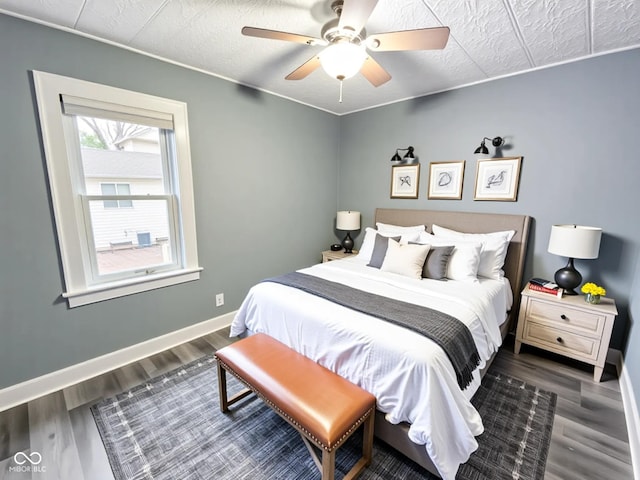 1627 E 8th St, Anderson, IN 46012 - bedroom featuring a ceiling fan, wood finished floors, and baseboards